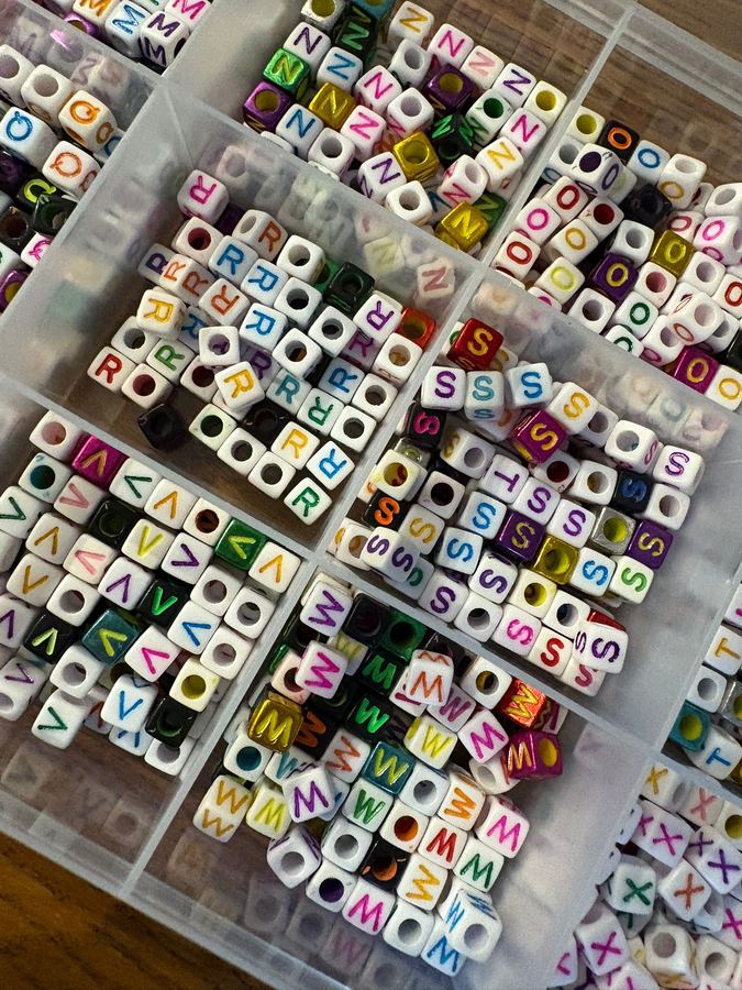 Hundreds of letter beads sorted by hand at Bright Strides